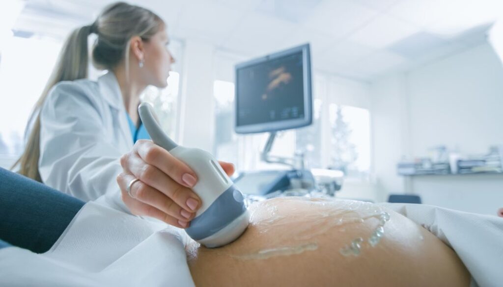 doctor doing ultrasound on a pregnant woman