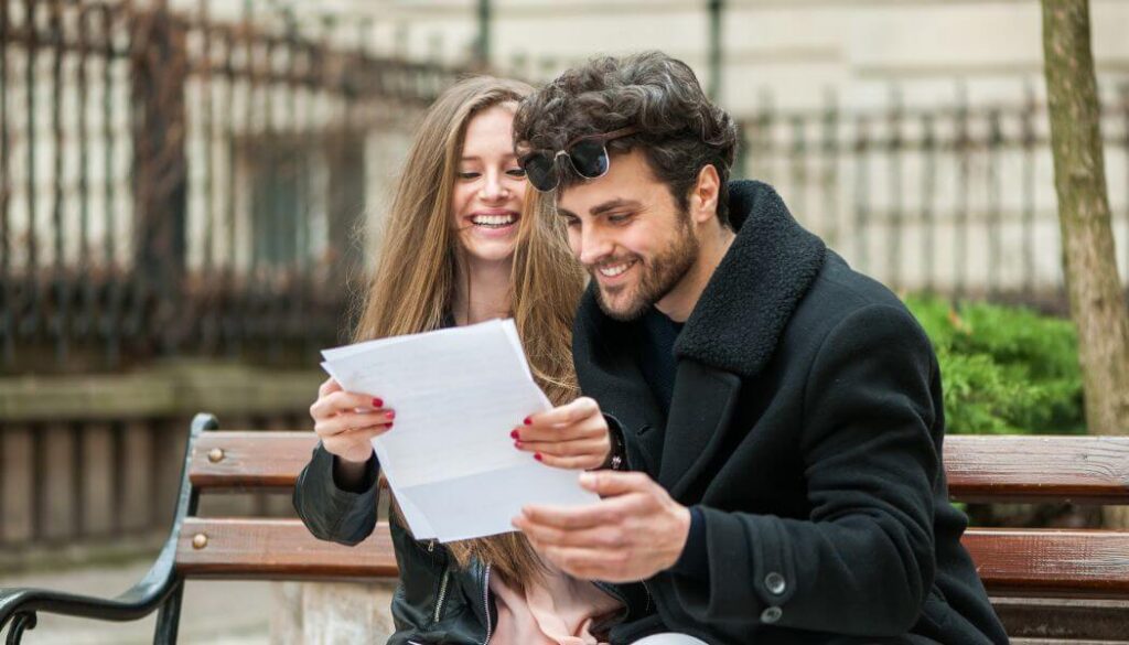 excited couple reading a letter