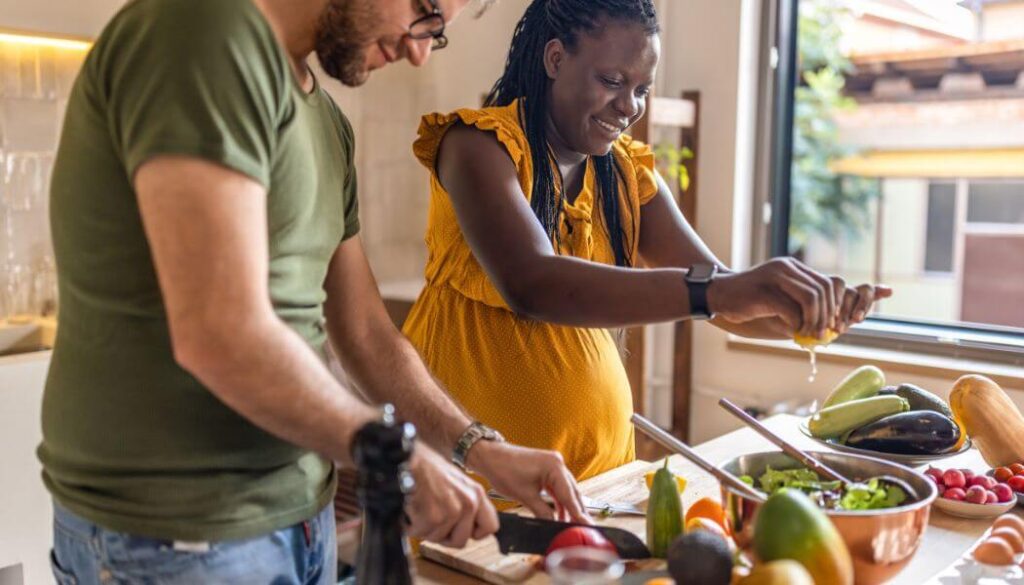 pregnant couple cooking together