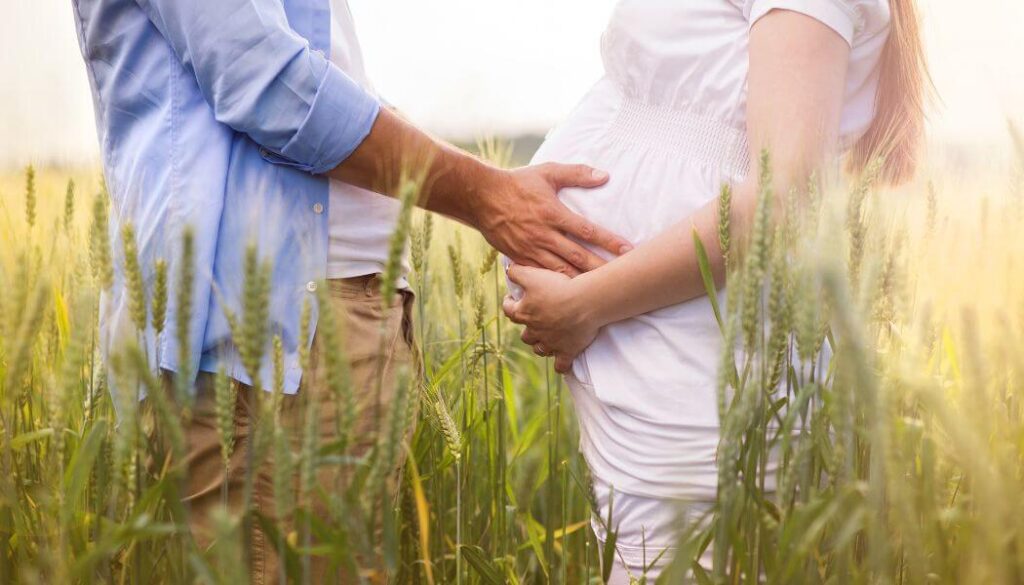 pregnant couple in nature