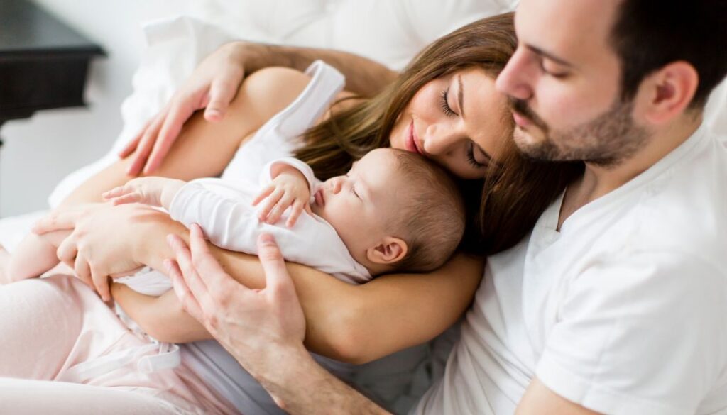 couple looking at a newborn