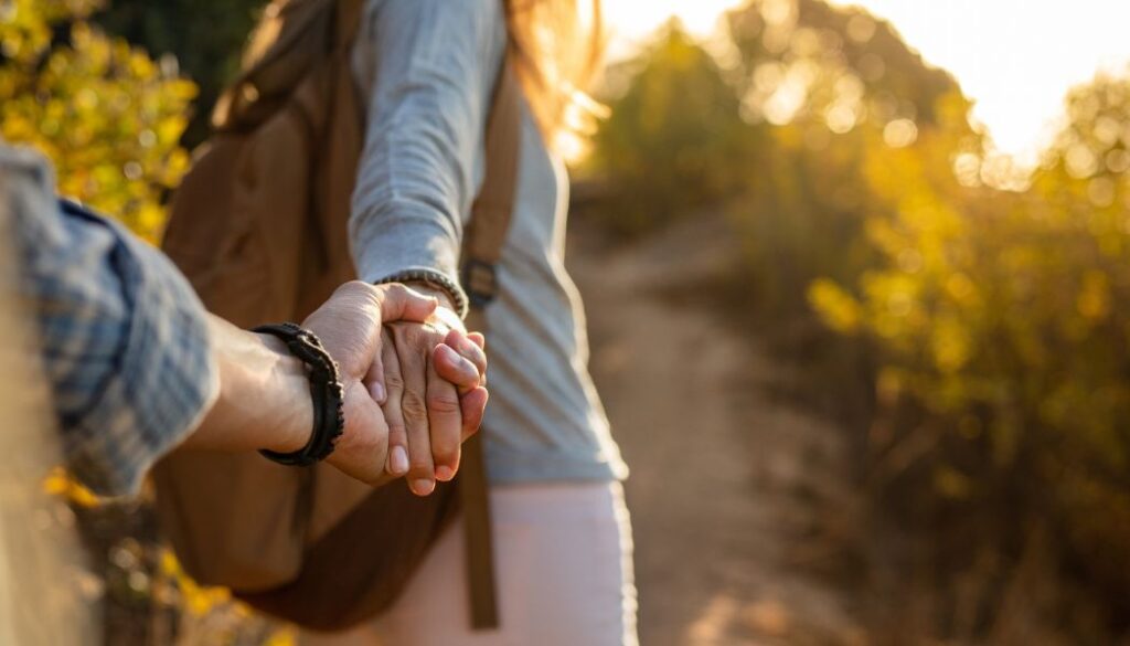 couple walking in nature holding hands