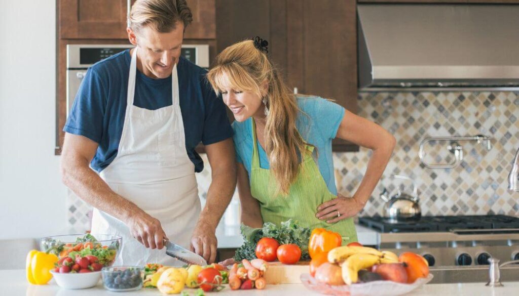 husband cooking with pregnant wife