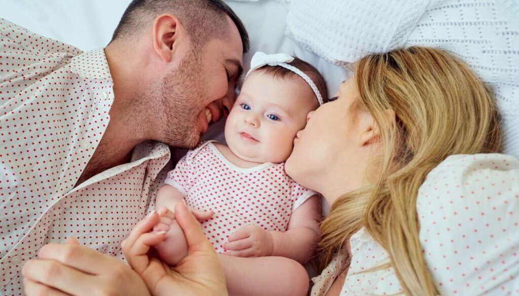 mom and dad looking at baby