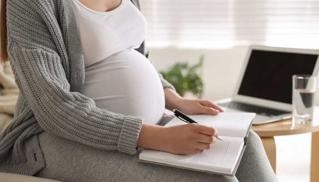 pregnant woman writing letter