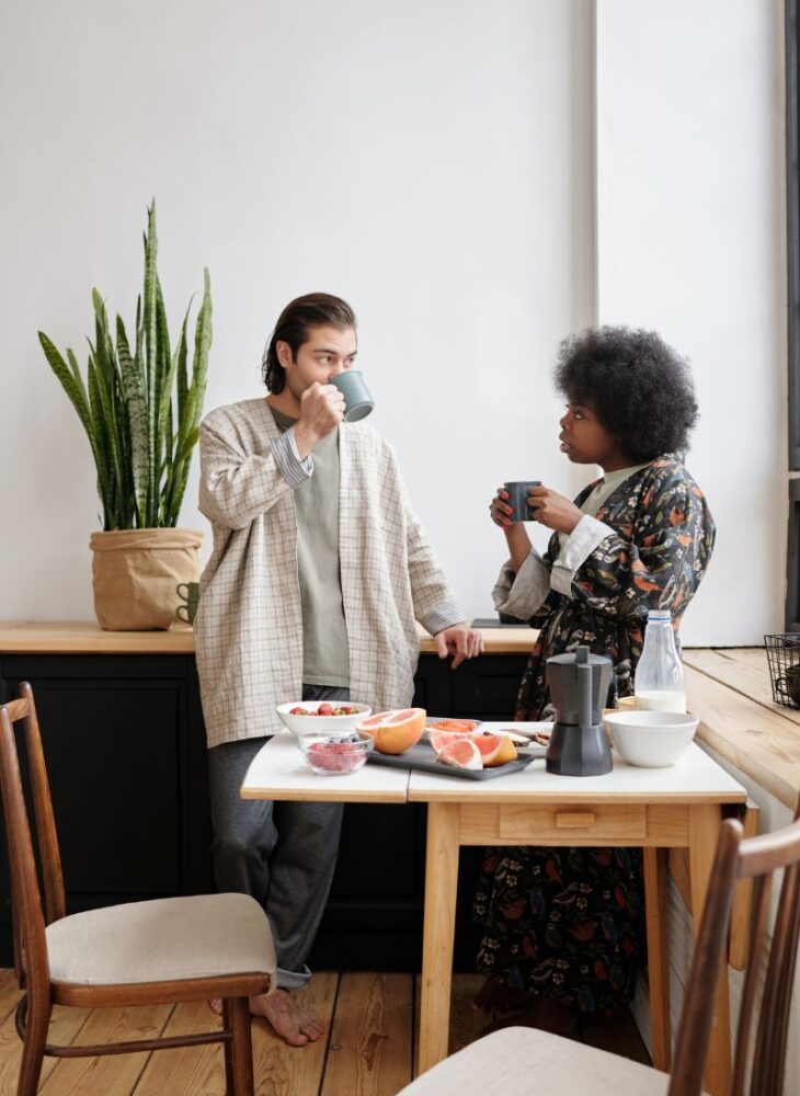 man and woman talking and drinking coffee