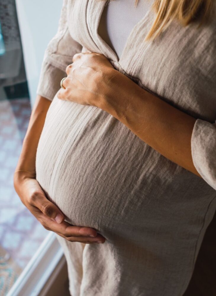pregnant woman holding belly