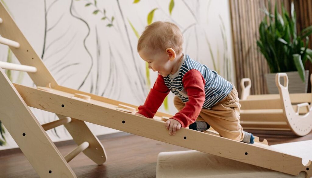 baby climbing on a toy ladder