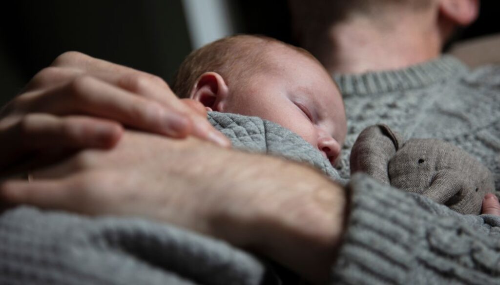 dad sleeping with a baby