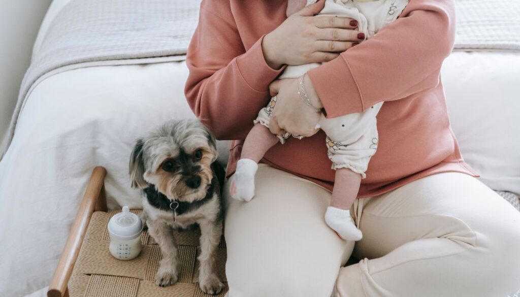 mom and baby with a dog