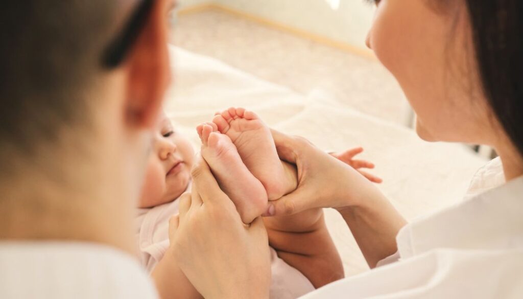 mom and dad holding the baby