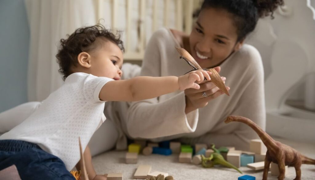 mom playing with baby with toys