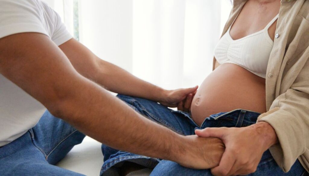 pregnant woman and man talking at home