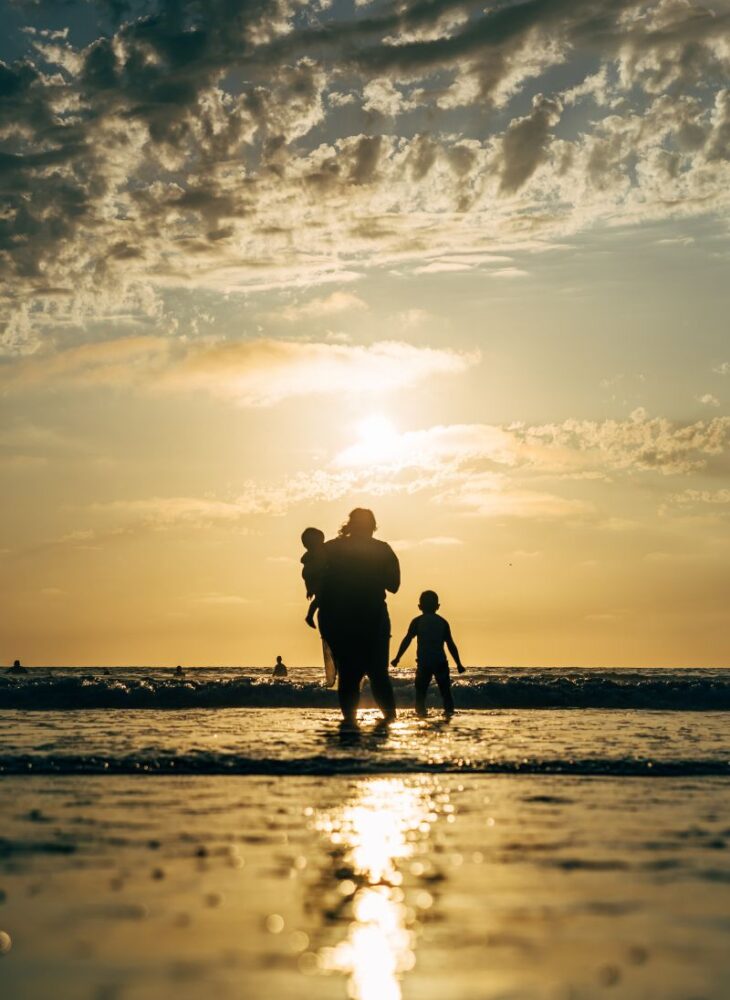 family at sunset on a beach
