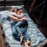 man and woman lying on a bed