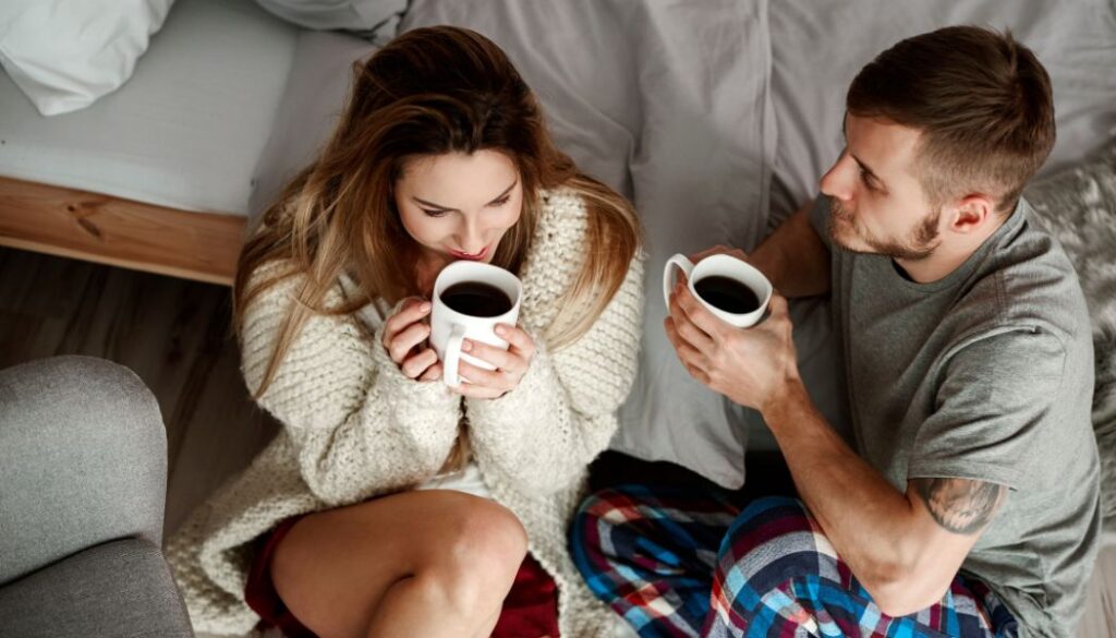 couple drinking coffee in bed