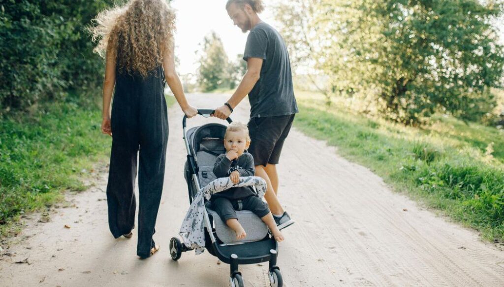 couple walking baby in a stroller