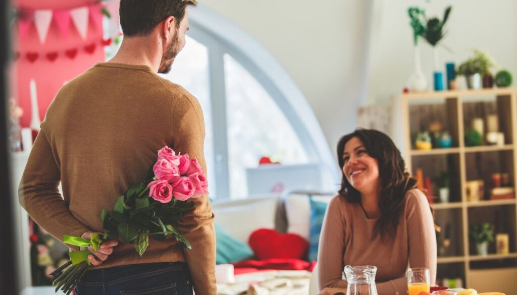 husband bringing flowers to wife