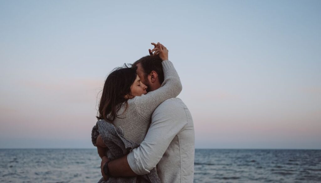 couple on a beach hugging